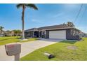 Charming single-story home with a spacious driveway and well-maintained landscaping at 5202 Forbes Ter, Port Charlotte, FL 33981