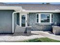 Inviting front entrance with stone accents, decorative lighting, and tiled walkway at 5202 Forbes Ter, Port Charlotte, FL 33981