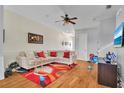 Cozy living room featuring plush seating, a ceiling fan, and natural light, creating a comfortable and inviting space at 8614 Miramar Terrace Cir, Temple Terrace, FL 33637