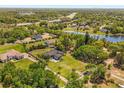 Expansive aerial view of a home on a large lot with mature trees, a pond, and easy highway access at 16805 Tobacco Rd, Lutz, FL 33558