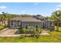 Beautiful home featuring lush landscaping, a basketball court, and a welcoming entrance at 16805 Tobacco Rd, Lutz, FL 33558