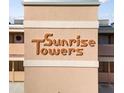 Close up of a tan building displaying the 'Sunrise Towers' sign at 2486 Caring Way # 17A, Port Charlotte, FL 33952