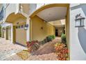 Covered walkway leads to the front door with brick pavers, garden bed, and exterior lighting at 4062 Overture Cir # 4062, Bradenton, FL 34209