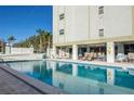 Inviting outdoor pool with lounge seating and a spacious deck area under a sunny blue sky at 7321 Central Ave # 504, St Petersburg, FL 33710