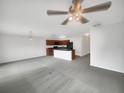 Spacious living area with modern gray carpet and an open layout flowing into the kitchen, ideal for entertaining at 11510 Southern Creek Dr, Gibsonton, FL 33534