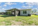 Spacious backyard with a screened-in patio area, perfect for outdoor relaxation and entertaining at 12387 Eastpointe Dr, Dade City, FL 33525