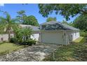 Well-maintained single-Gathering home with a spacious driveway and attached two-car garage at 13405 Fawn Springs Dr, Tampa, FL 33626