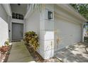 Charming home exterior with a well-manicured lawn, pathway to front door, and two-car garage at 13405 Fawn Springs Dr, Tampa, FL 33626