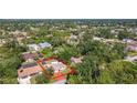 Aerial view of the home showcasing its location within a lush, green neighborhood and the proximity to mature trees at 1481 Newton St, Port Charlotte, FL 33952