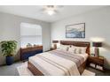Relaxing main bedroom with a plush bed, modern decor, and a view of the outdoors through bright windows at 2007 Rain Dance Pl, Brandon, FL 33510
