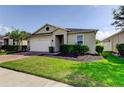 Well maintained single-story home features a nicely manicured front lawn at 25242 Carnation Sedge Way, Land O Lakes, FL 34639