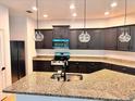 Modern kitchen features granite countertops, stainless appliances, dark cabinets, and pendant lighting at 25242 Carnation Sedge Way, Land O Lakes, FL 34639