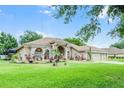 Charming ranch-style home with manicured lawn, complemented by mature landscaping at 12320 Creek Edge Dr, Riverview, FL 33579