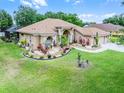 Charming ranch-style home with manicured lawn, complimented by mature landscaping at 12320 Creek Edge Dr, Riverview, FL 33579