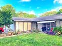 Lovely single-story home featuring a well-kept lawn, and decorative plants alongside the walkway at 1420 Citrus St, Clearwater, FL 33756