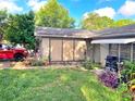 Front yard view of single-story home with decorative plants along the walkway and a red truck in the driveway at 1420 Citrus St, Clearwater, FL 33756