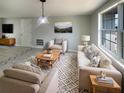Inviting living room with plush seating, natural light, and stylish decor atop patterned area rug at 3213 Bigelow Dr, Holiday, FL 34691