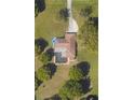 Aerial view of home with a private pool and expansive, well-manicured yard at 3652 Oak Grove Dr, Sarasota, FL 34243