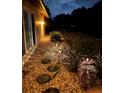 Scenic walkway with stone steps and garden lighting, leading to a lush, landscaped yard at 3652 Oak Grove Dr, Sarasota, FL 34243
