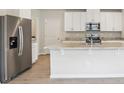 Modern kitchen features white cabinets, stainless steel appliances, and an island at 2320 E Newsome Rd, Plant City, FL 33565