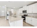 Bright kitchen with white cabinets, stainless steel appliances, and island at 2320 E Newsome Rd, Plant City, FL 33565