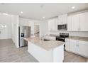 Bright kitchen with stainless steel appliances, granite countertops, and a kitchen island at 3826 Radiant Mountain Dr, Plant City, FL 33565