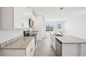 Modern kitchen featuring white cabinets, granite countertops, and stainless steel appliances at 3826 Radiant Mountain Dr, Plant City, FL 33565