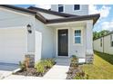 Inviting entrance featuring a sleek black front door and neutral-toned exterior finishes at 3904 Radiant Mountain Dr, Plant City, FL 33565