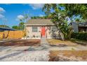 Charming single-story home with a well-maintained lawn and a bright red front door at 2333 33Rd S St, St Petersburg, FL 33712
