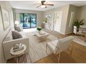 Bright living room featuring a large window, neutral-toned walls, modern furnishings, and tile flooring at 1424 Pine Glen Ln # D2, Tarpon Springs, FL 34688