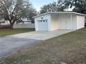 Detached garage with ample parking space and a clean, white exterior at 4435 Tevalo Dr, Valrico, FL 33596