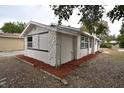 View of single story home with white stucco and stone accents and updated windows and landscaping at 316 21St W St, Palmetto, FL 34221