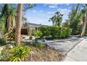Charming home surrounded by lush landscaping, plants, and a white gravel yard at 913 Tennessee Ln, Sarasota, FL 34234