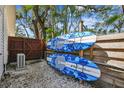 Functional side yard features a pair of surfboards mounted on the fence at 913 Tennessee Ln, Sarasota, FL 34234