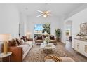Bright living room featuring neutral tones, plush furniture, and a serene lake view from the sliding glass doors at 12511 Lake Vista Dr, Gibsonton, FL 33534
