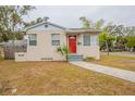 Charming single-story home with a bright red front door and well-maintained lawn at 2001 16Th S St, St Petersburg, FL 33705