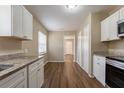 Bright kitchen with white cabinets, granite countertops, and wood flooring at 2001 16Th S St, St Petersburg, FL 33705