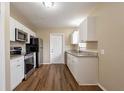 Modern kitchen featuring white cabinets, stainless steel appliances, and granite countertops at 2001 16Th S St, St Petersburg, FL 33705