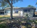 Single story home with large windows and a white front door at 316 Country Club Dr, Oldsmar, FL 34677