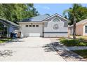 Front exterior featuring a well-maintained lawn, a two car garage and a driveway, highlighting suburban comfort at 754 Cape Cod Cir, Valrico, FL 33594