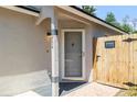 Inviting front entry with decorative door, secured gate, and a 'Beware of Dog' sign at 754 Cape Cod Cir, Valrico, FL 33594