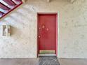 Red door to the condo unit 57, with a 