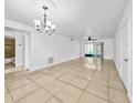 Spacious living room with tile floors, ceiling fan, and sliding glass doors to the outside at 8608 Huron Ct # 57, Tampa, FL 33614