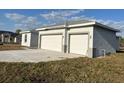 Well-maintained home featuring a large driveway and attached two-car garage at 2310 Logsdon St, North Port, FL 34287