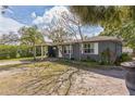 Inviting front exterior with a covered area and lush, green landscaping at 3424 19Th N St, St Petersburg, FL 33713