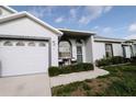 Charming home featuring a well-manicured lawn and inviting entry with cozy outdoor seating at 4217 Avanti Cir, New Port Richey, FL 34655