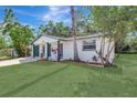 This house has a lush lawn, a palm tree, and manicured landscaping that complements the painted brick facade at 1024 Applewood Dr, Clearwater, FL 33759