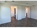 Spacious bedroom featuring tiled floors and views to ensuite bathroom and walk-in closet at 25126 Calusa Dr, Punta Gorda, FL 33955