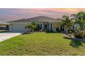 Charming one-story home boasts a well-manicured lawn and beautiful landscaping at 2248 Bonn Ct, Punta Gorda, FL 33983