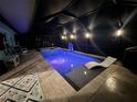 Evening view of a pool and spa illuminated with purple LED lighting at 2248 Bonn Ct, Punta Gorda, FL 33983
